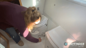 Final touches on cleaning the composting toilet