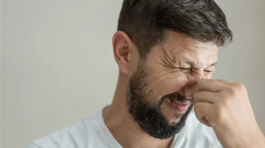 A person rubbing their nose.