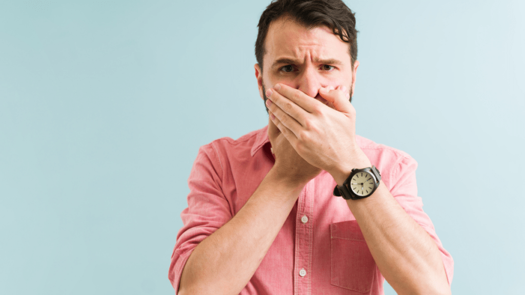 man covering his nose from bad smell | how to eliminate composting toilet smells