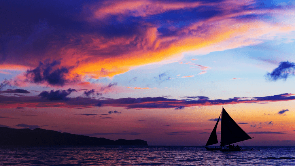 Sailboat with a beautiful sunset background | Composting toilet for ocean passages