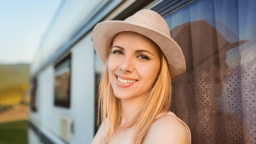 Smiling women on camping adventure with her RV
